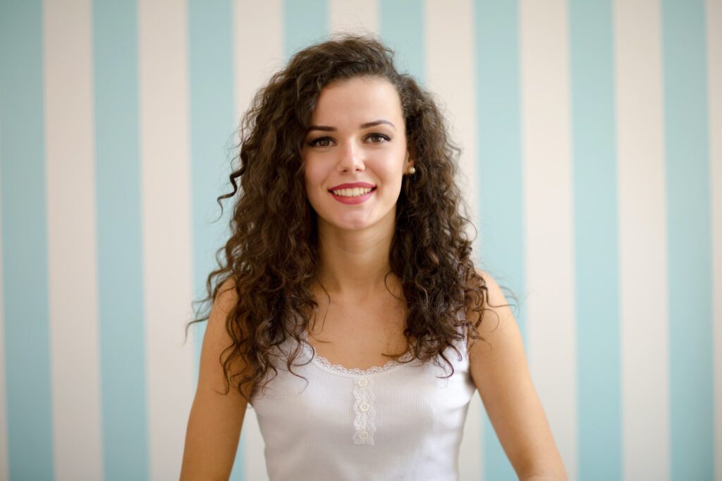 Beautiful woman with curly hair smiling