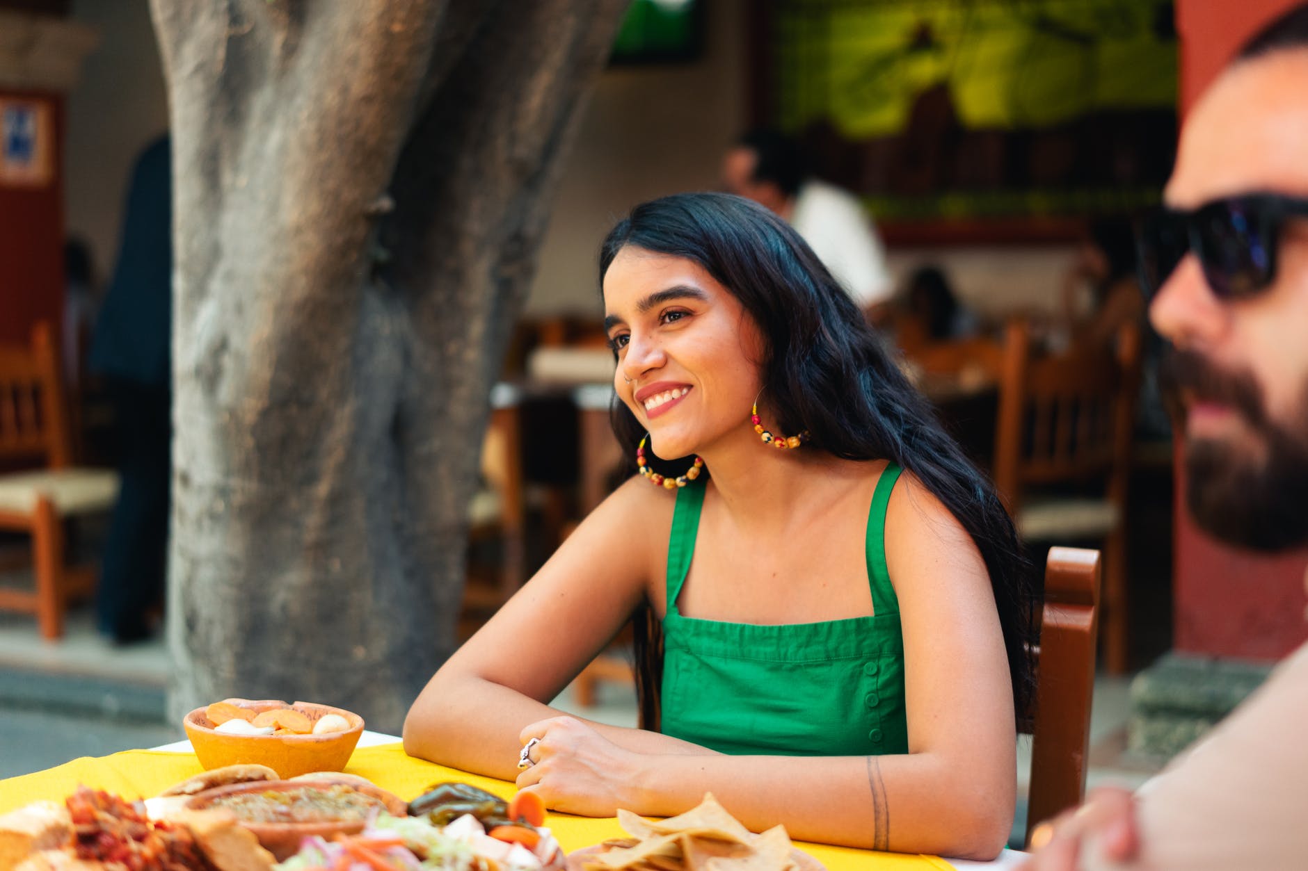 woman in green tank top eating mexican food
