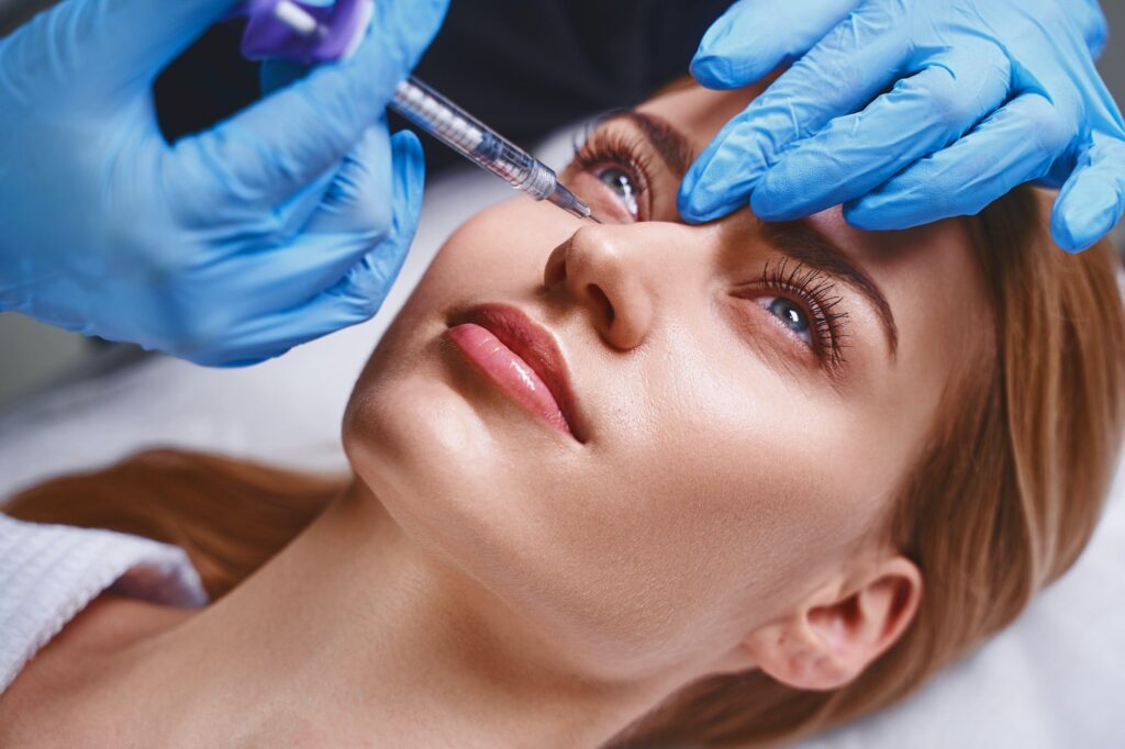 Female is trying antiage fillers stock photo