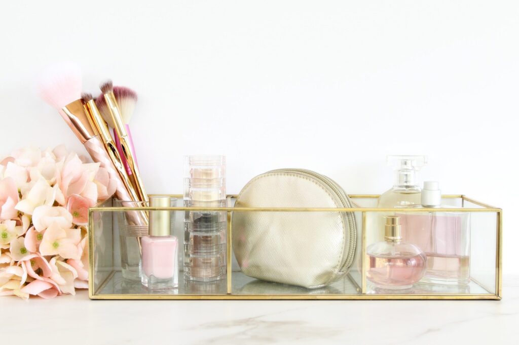 Glass storage if makeup and perfumes with copy space