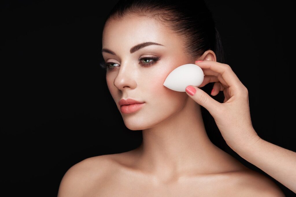 Makeup artist applies skintone