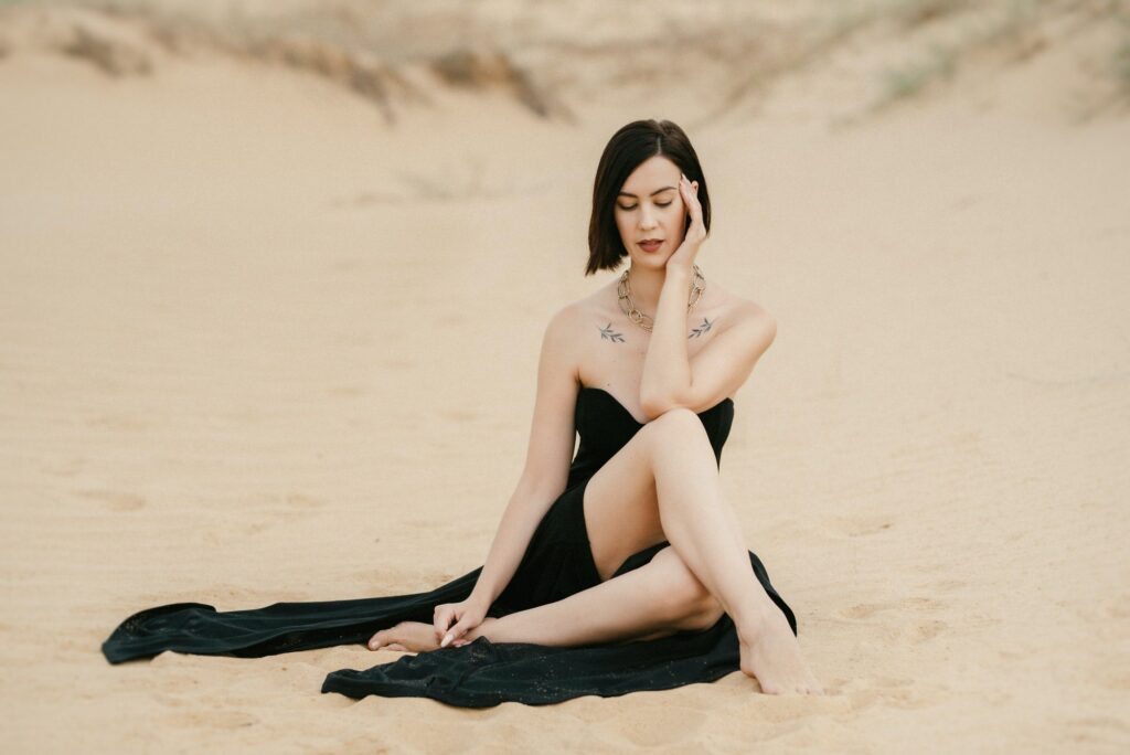 girl in a black long dress in a sandy desert