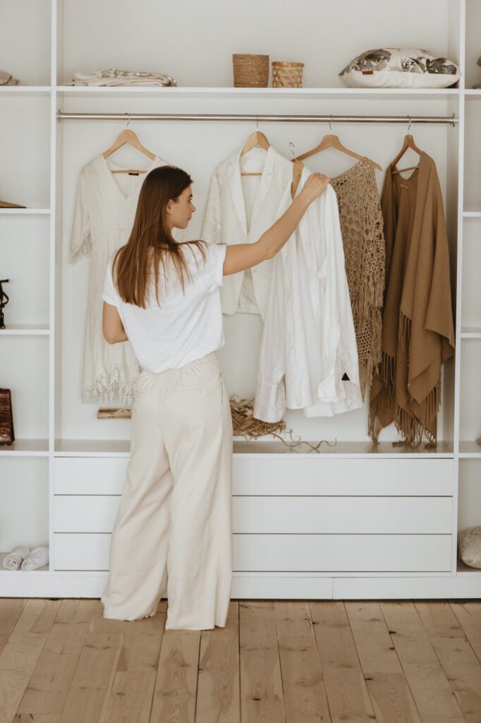 Woman picking clothes from the wardrobe.